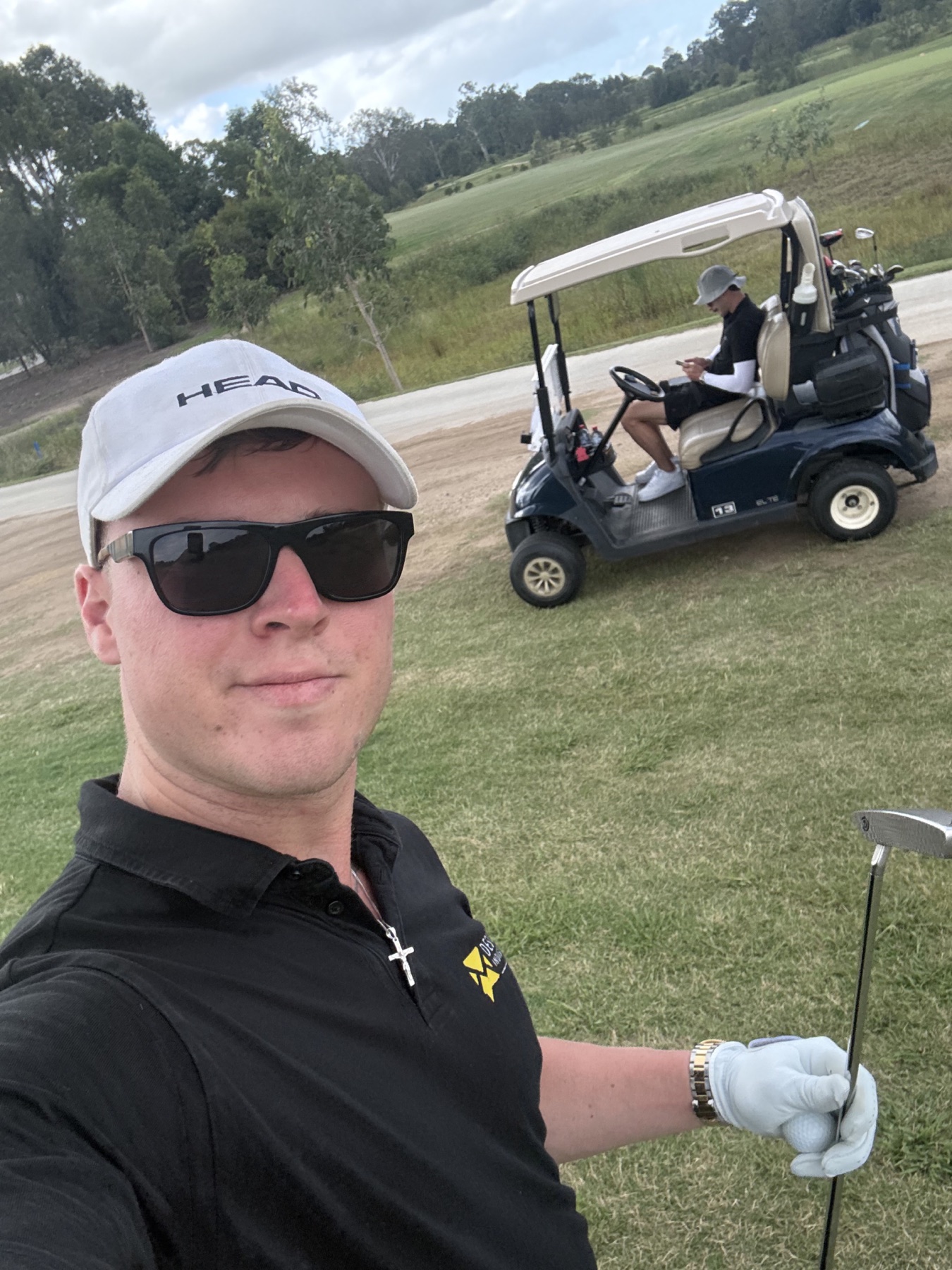 A golfer and cart on the course