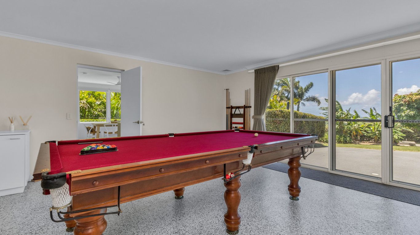 The full-size pool table in its own light-filled games room